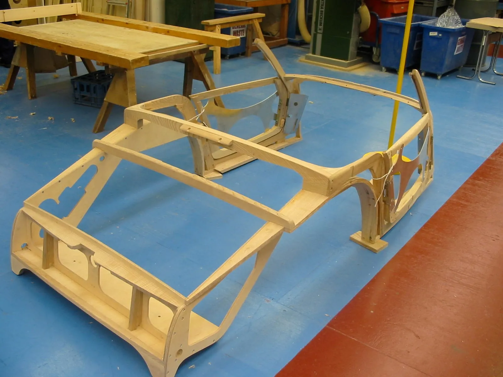 A bare wooden frame for an Aero 8 on the workshop floor