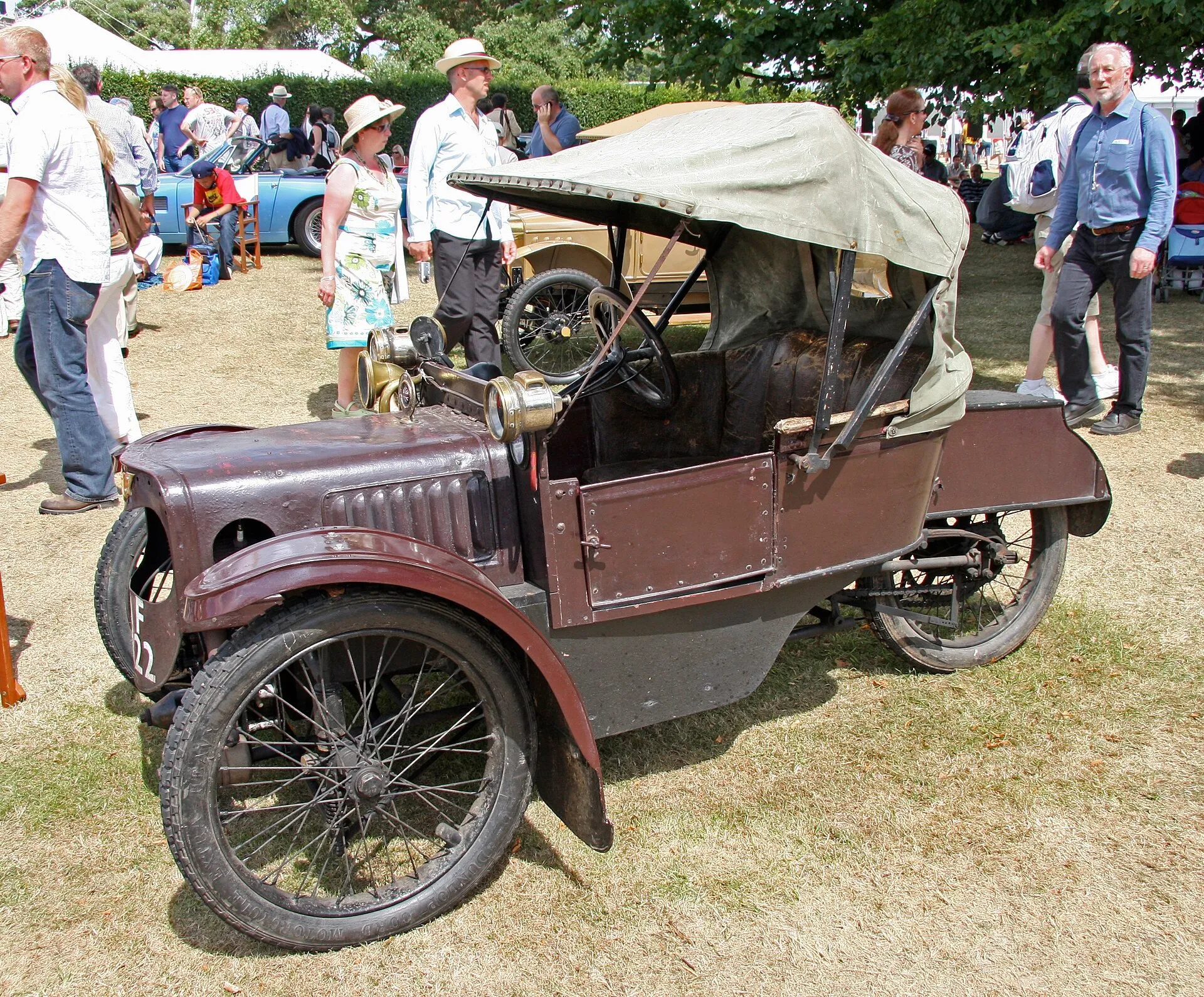 A 1912 Morgan Runabout De Luxe three-wheeler at a show, side view