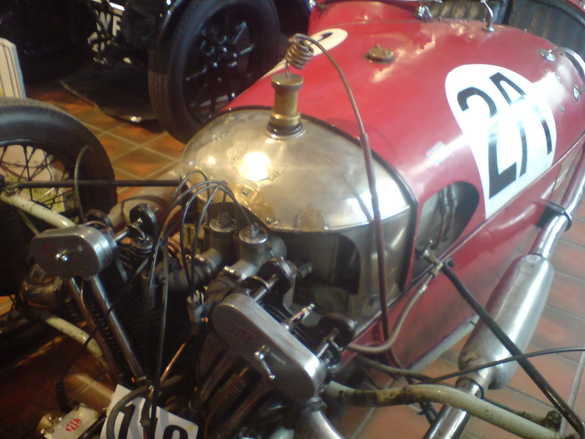 A red Morgan three-wheeler with race number 28 and a large V-twin engine, at Brooklands Museum