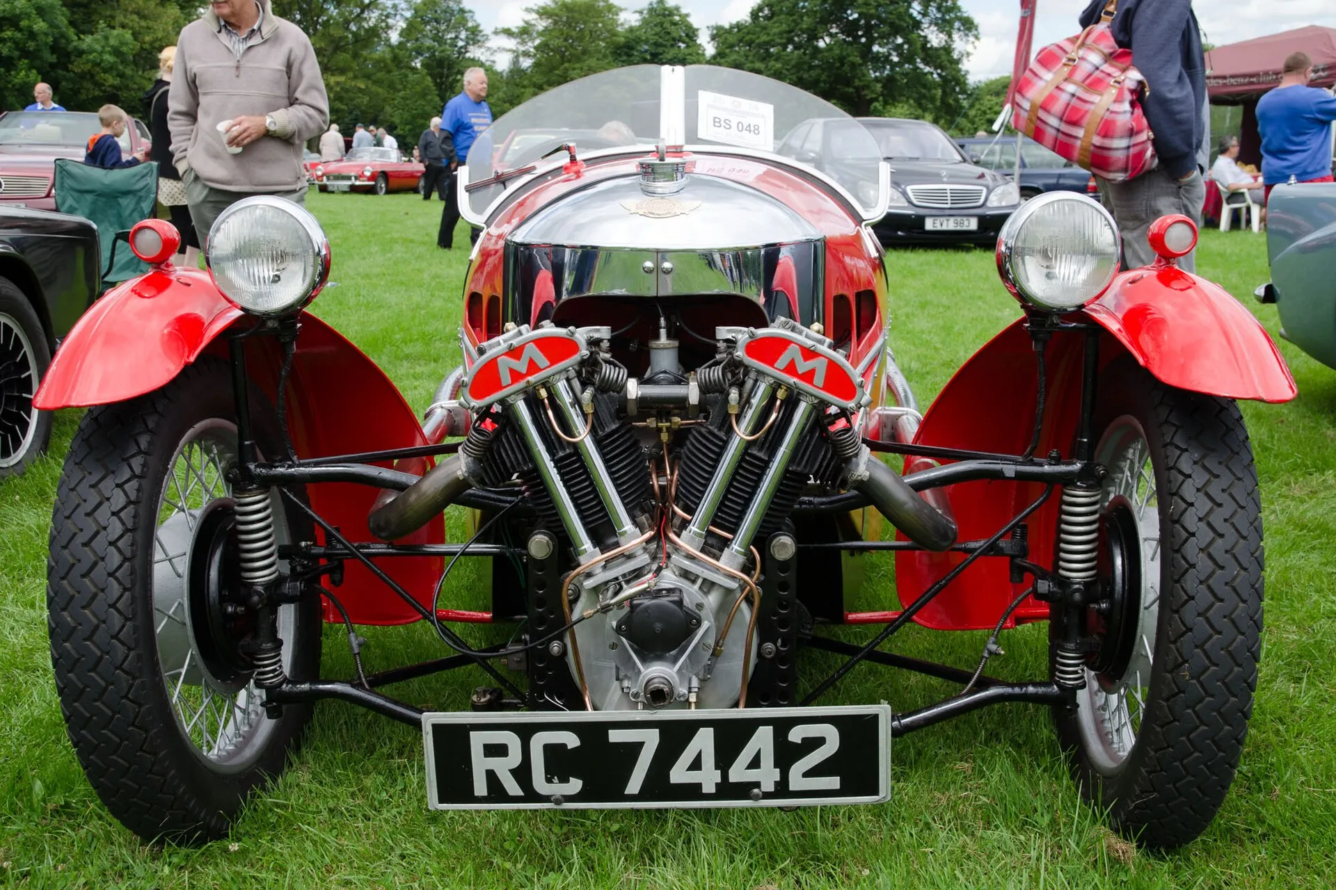 A red 1939 Morgan three-wheeler seen head-on, with its twin headlamps and Matchless V-twin engine