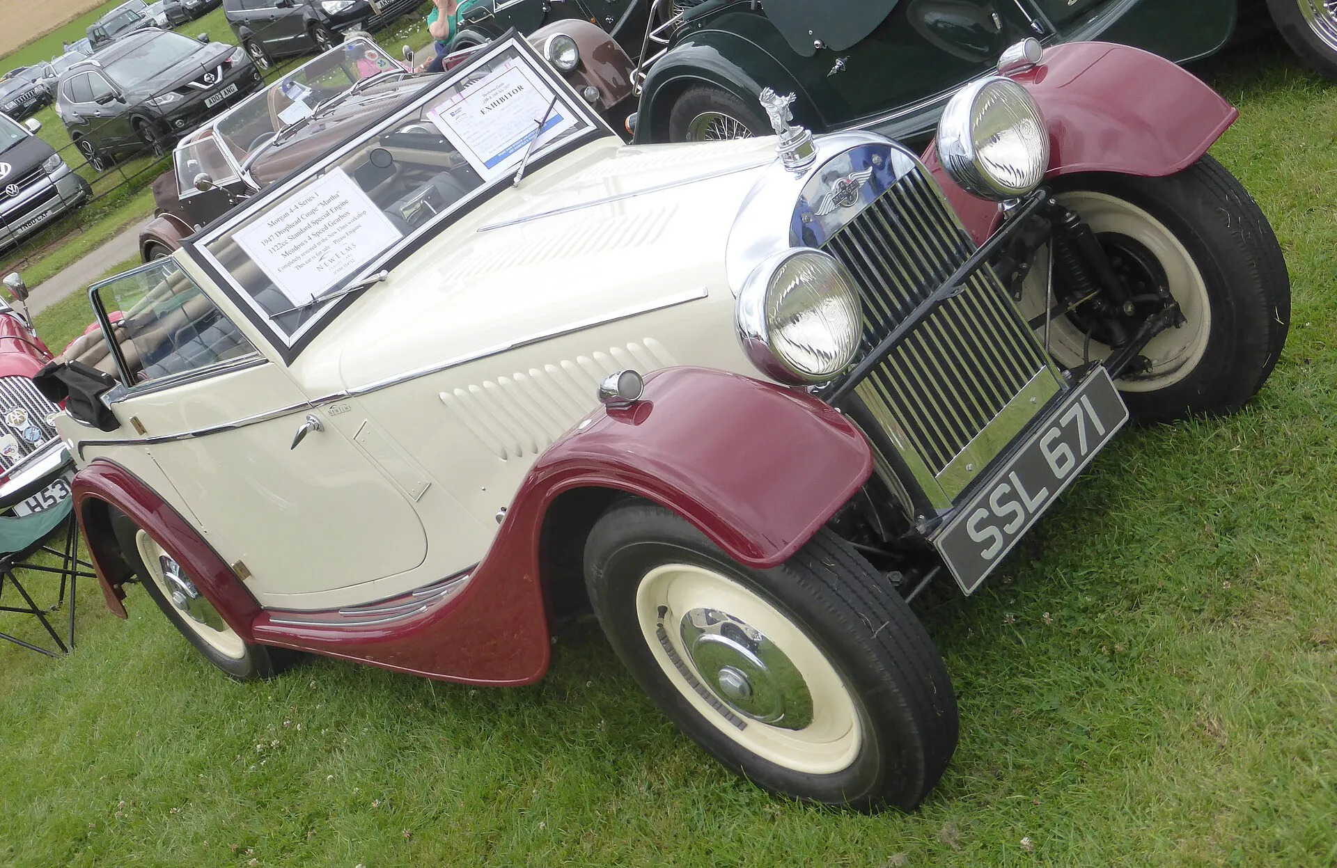 A cream and maroon 1947 Morgan 4-4 drophead coupé at an outdoor show