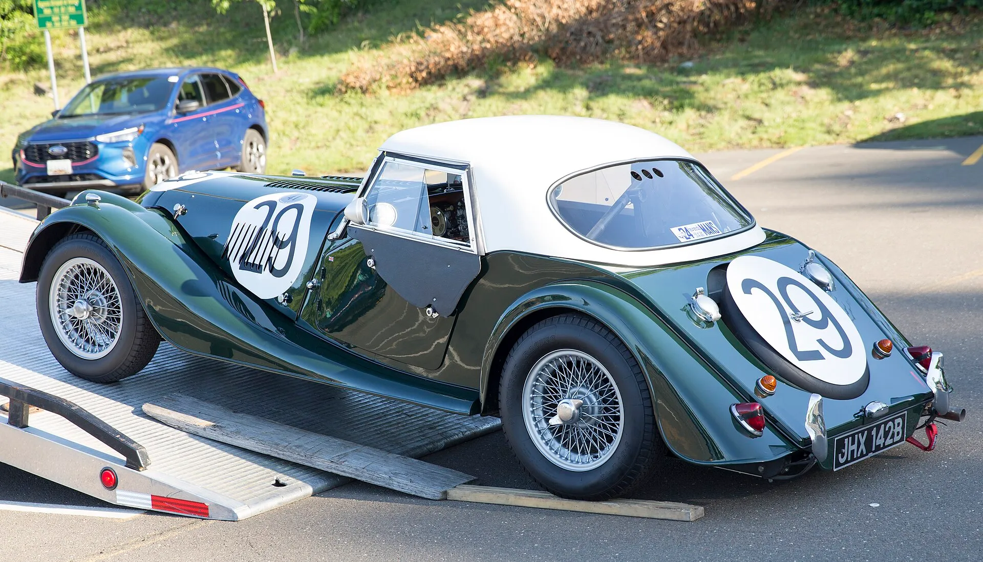 The rear of a green Morgan Plus 4 Super Sports with a white hardtop and race number 29