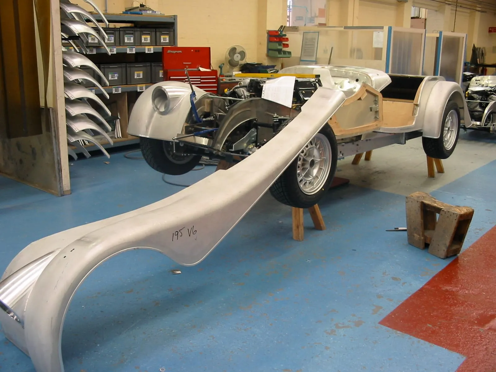 A long aluminium wing laid across a Plus 8 on trestles
